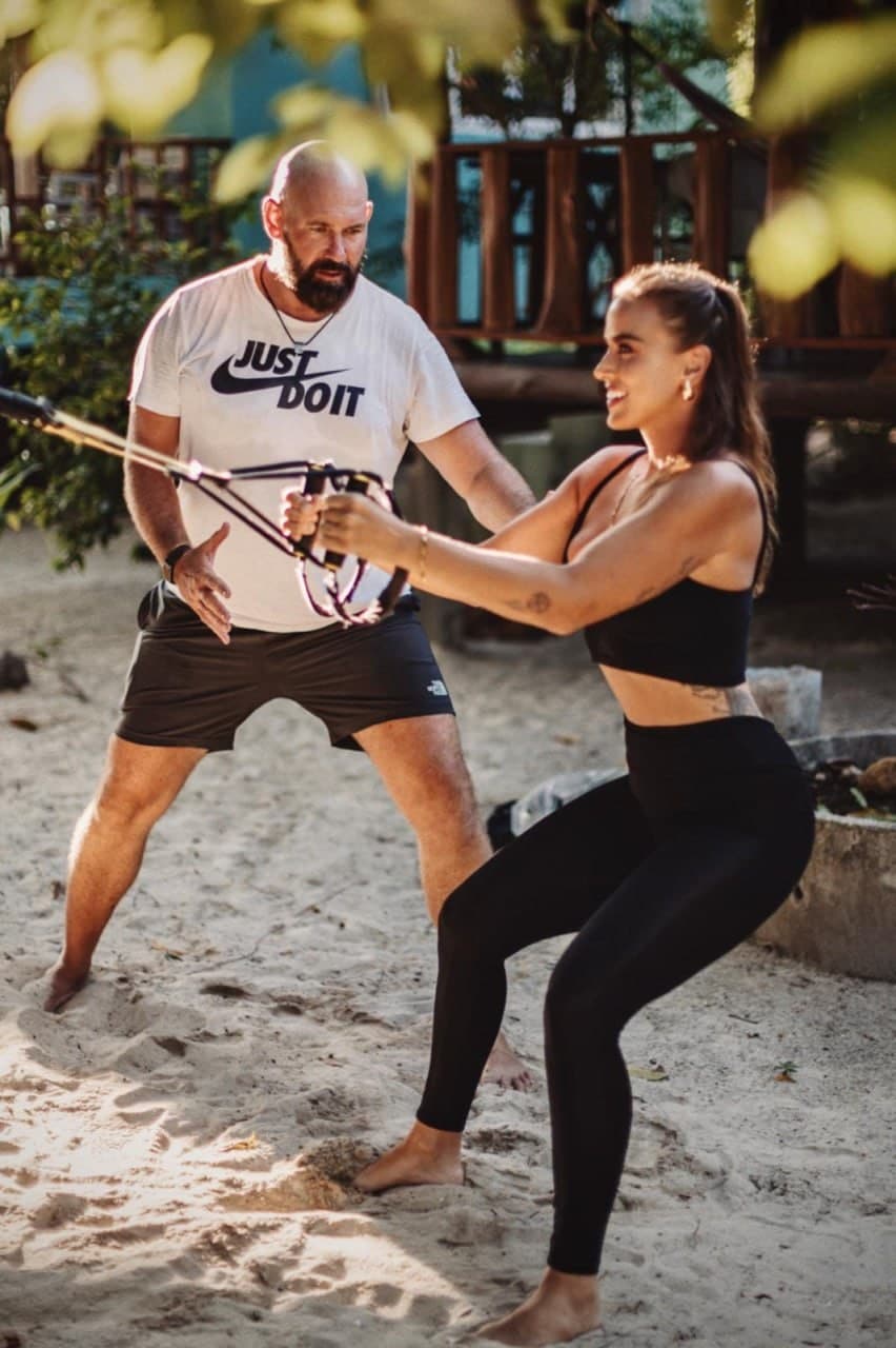 Mirko leading a banded exercise on the beach